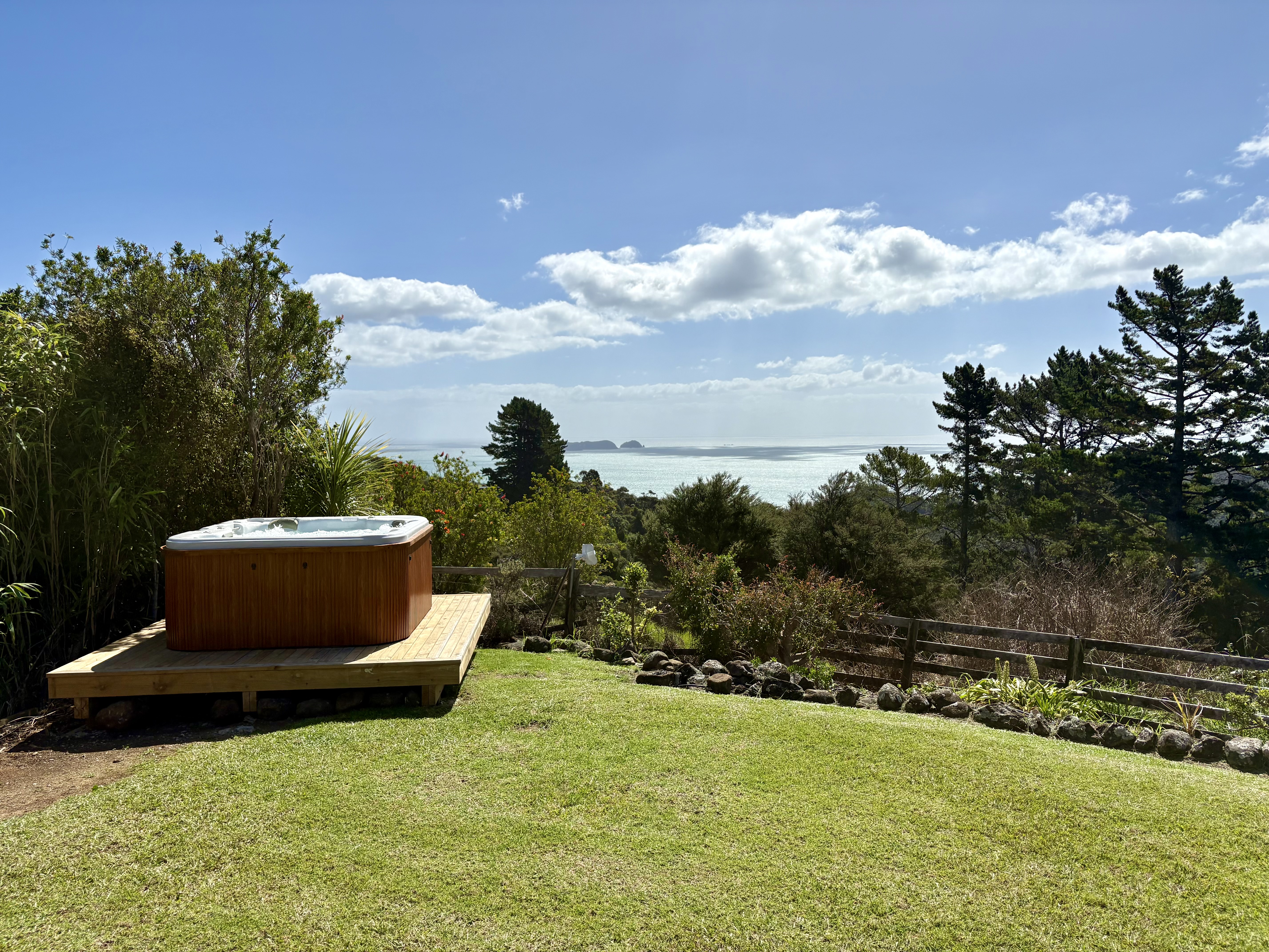 Luxury farm stay accommodation with outdoor spa pool and ocean views at Whitestar Station, Colville. Perfect romantic getaway in Northern Coromandel.
