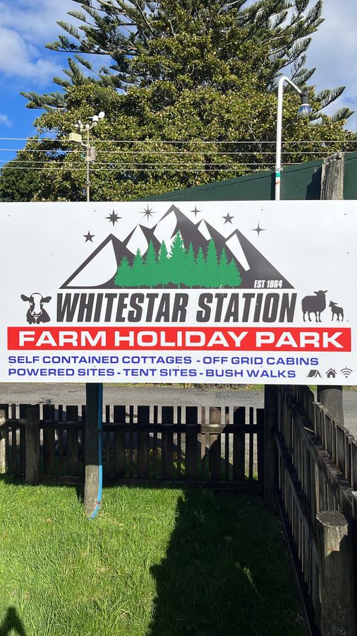 The entrance gate and road sign for Whitestar Station Farm Holiday Park at 2140 Colville Road, Northern Coromandel.